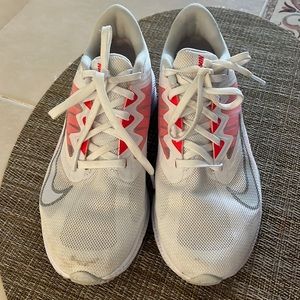 White Nike sneakers with coral and silver highlights